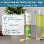 A bottle of Genuity Super B-Complex Effervescent tablets stands on a countertop beside a glass of yellow-green tea and a single round tablet, with a text callout describing benefits like methylated active forms and high potency.