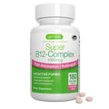 A white bottle of Igennus Super B12-Complex dietary supplement with a white cap, shown on a white background with four pinkish-beige tablets placed in front of the bottle.