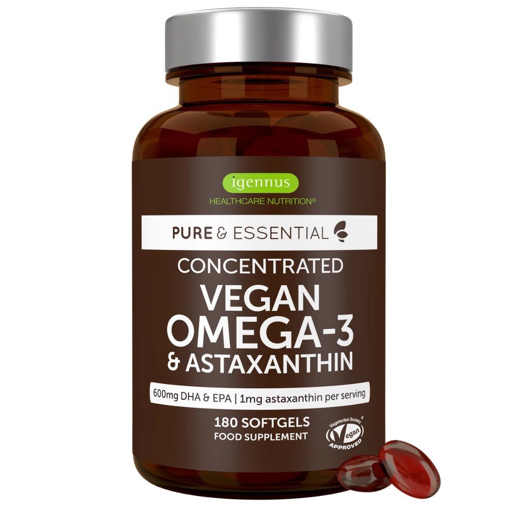 A brown amber bottle of Igennus Healthcare Nutrition Vegan Omega-3 & Astaxanthin softgels with a silver cap, shown on a white background with two red softgels in front.