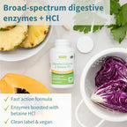 Bottle of digestive enzymes with pineapple, cabbage, and other ingredients on a white background