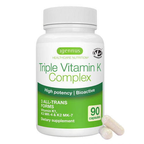A white plastic bottle of Igennus Triple Vitamin K Complex dietary supplement with green and white labeling, shown on a white background with two beige capsules in front.