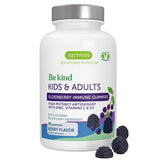 A white bottle of Igennus 'Be kind' Elderberry Immune Gummies with a silver cap, shown on a white background with three dark purple gummies in the foreground.